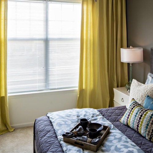 a bedroom with a bed and lamps