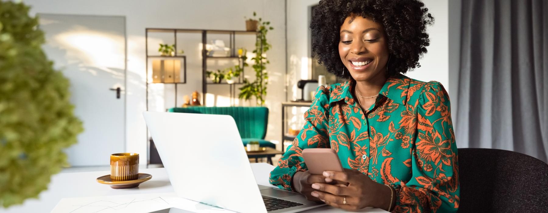 a person sitting at a table with a laptop