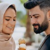 a man and woman holding ice cream cones